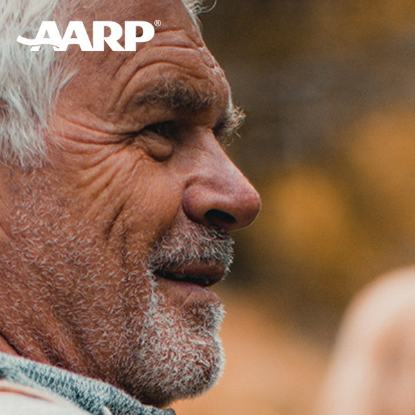 Side profile of a white, middle-aged man's face. He has gray hair and beard and the "AARP" logo is in the photo.