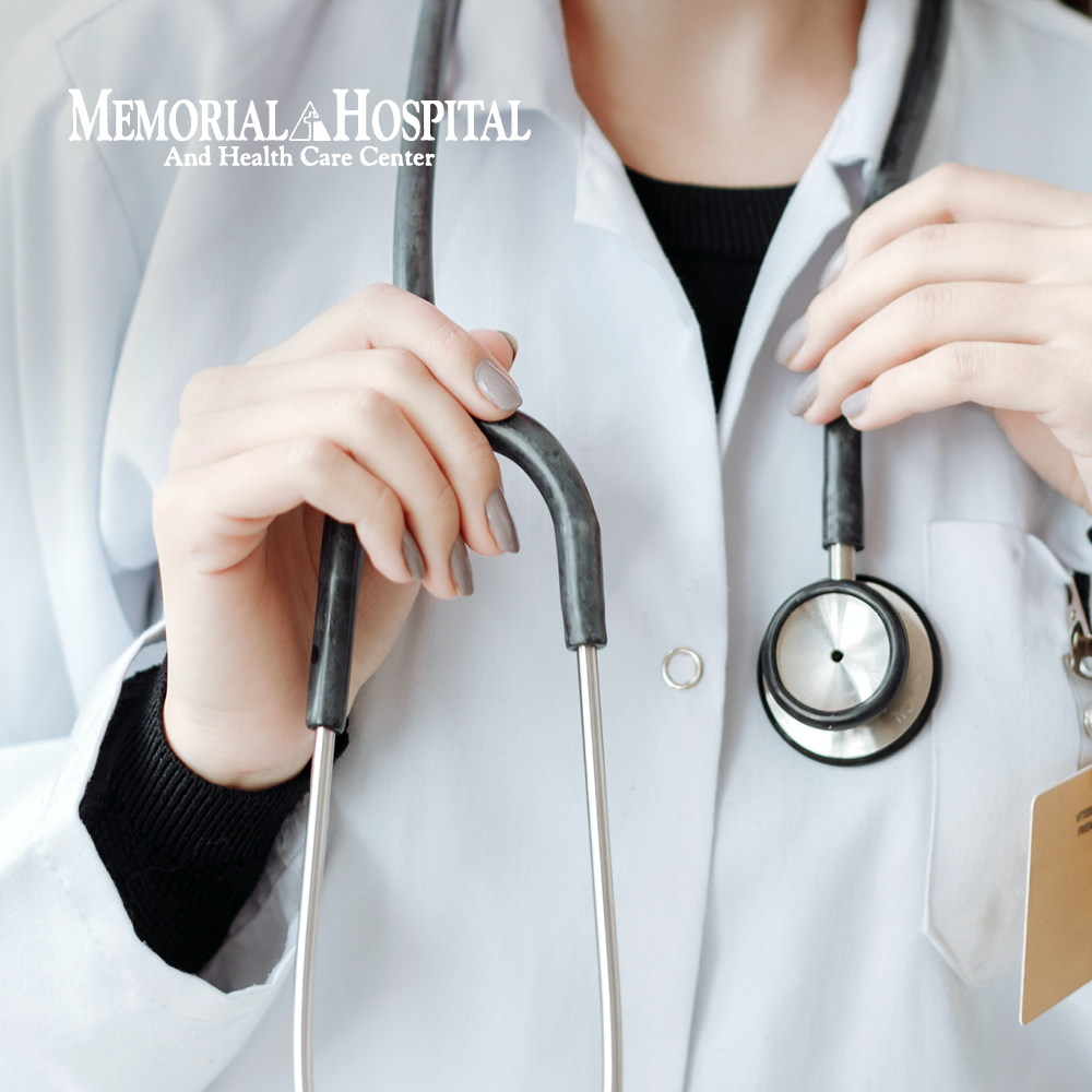 Image of a medical professional with their stethoscope. Text in the top left corner reads “Memorial Hospital And Health Care Center”.
