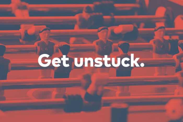Founder's syndrome and monoculture article feature image of a foosball table and the words "Get unstuck." overlaid
