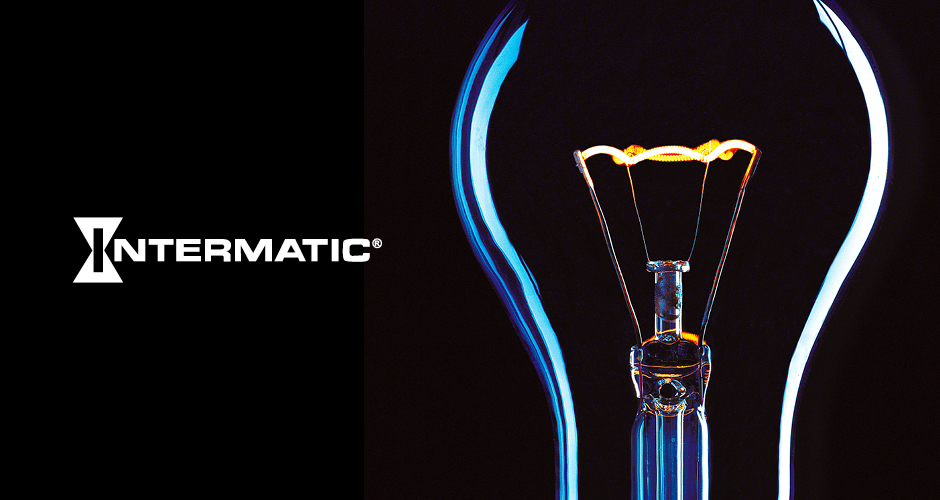 A dramatic close up shot of a lightbulb filament aglow in a dark space to the right, and a company logo that reads "Intermatic" to the left.